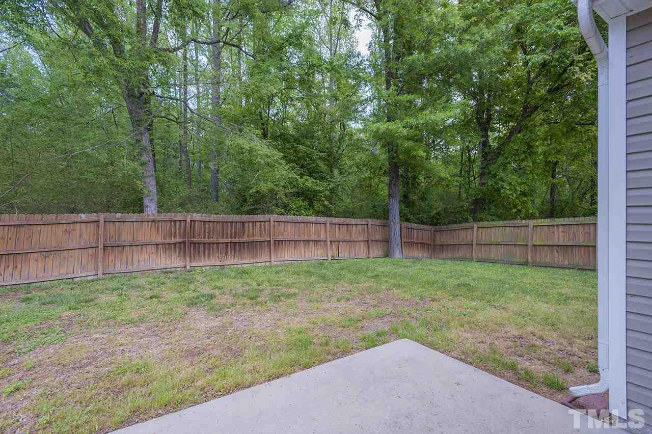 3239 Polite Lane Raleigh, NC 27610 - Photo 2 of 17 a view of a yard with a fence and trees