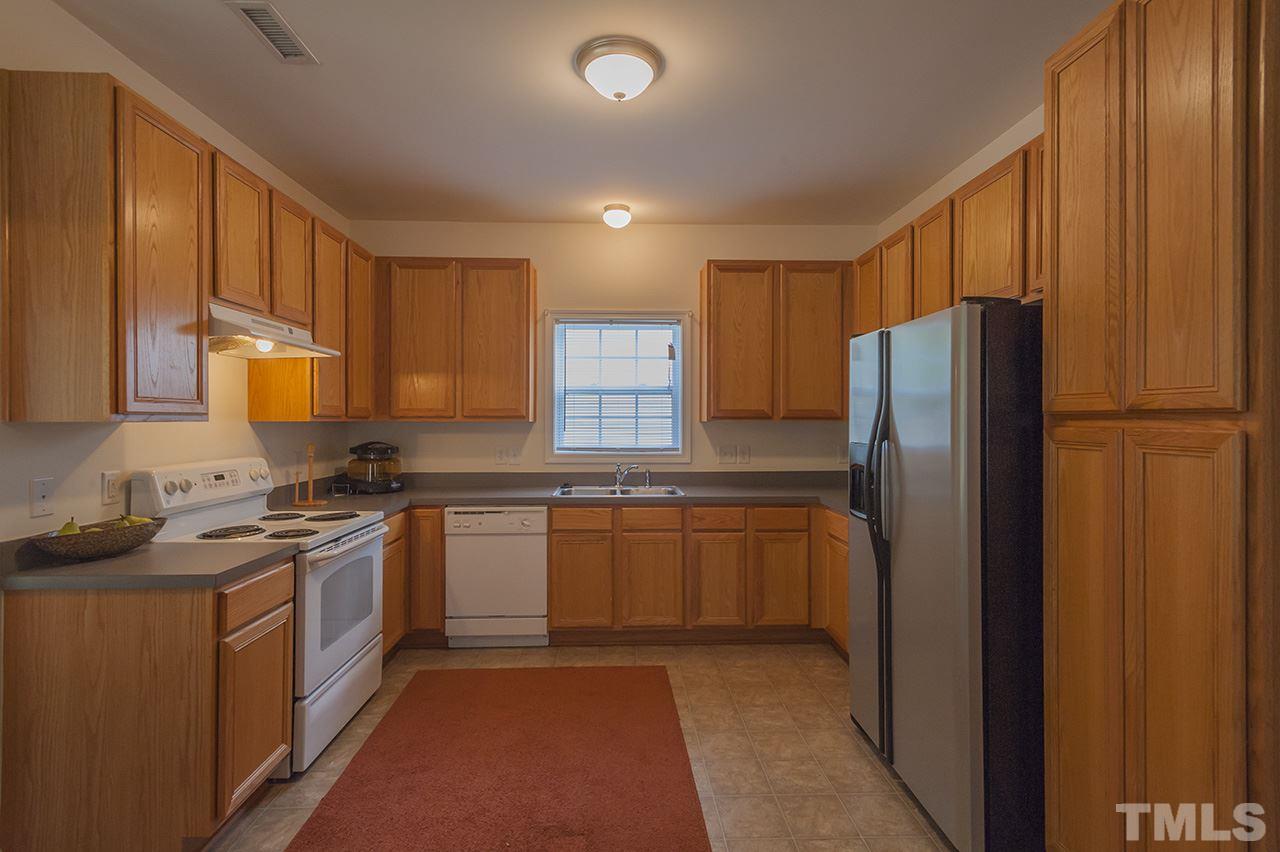 3239 Polite Lane Raleigh, NC 27610 - Photo 3 of 17 a kitchen with stainless steel appliances granite countertop a refrigerator a stove a sink and a microwave