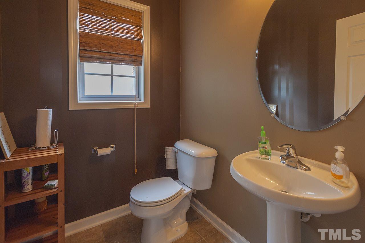 3239 Polite Lane Raleigh, NC 27610 - Photo 5 of 17 a bathroom with a toilet sink and mirror