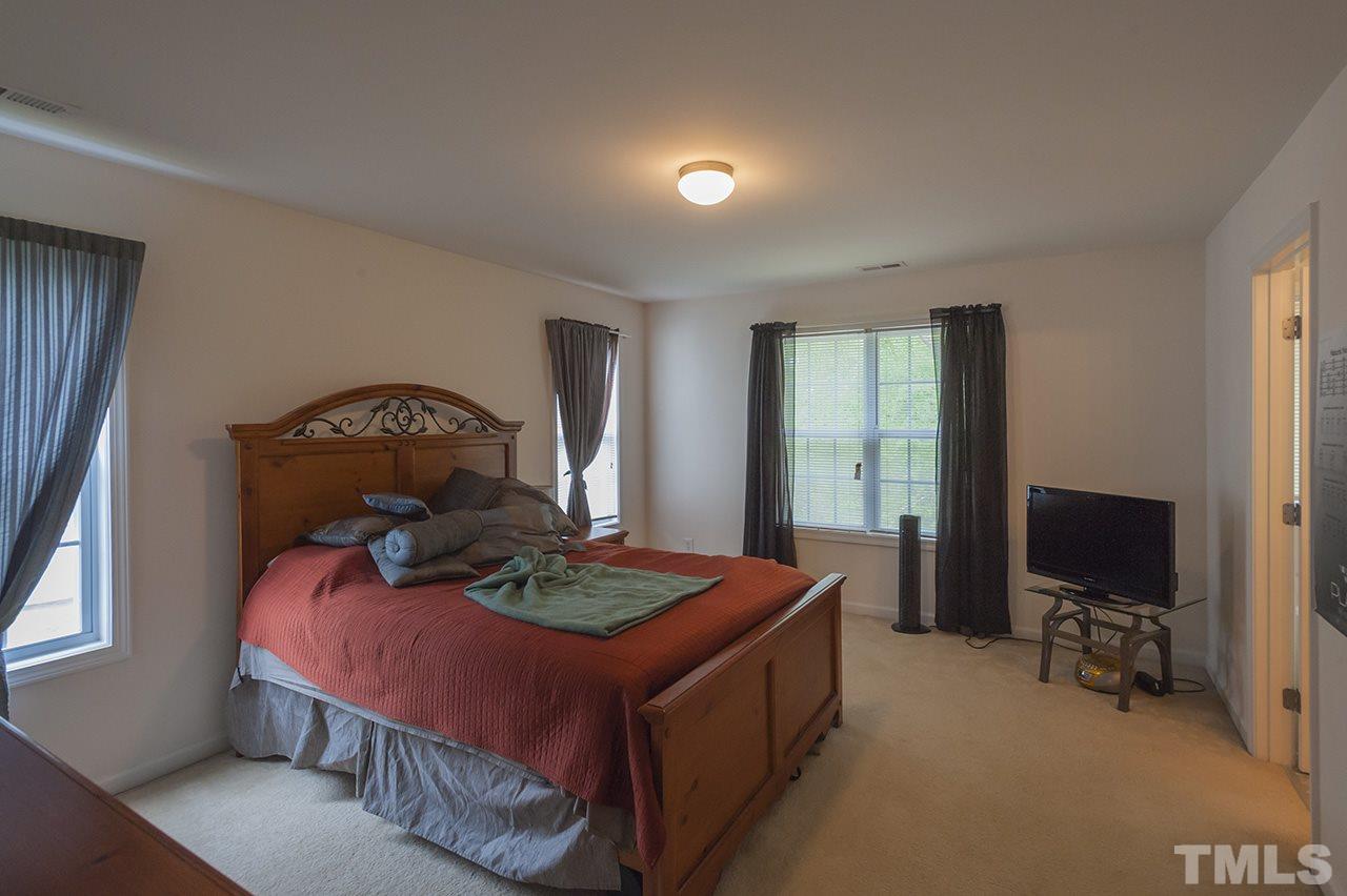 3239 Polite Lane Raleigh, NC 27610 - Photo 9 of 17 a bed room with furniture and a flat screen tv