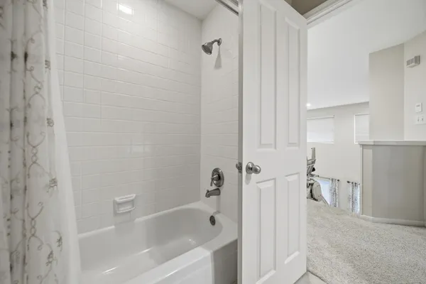 a view of a livingroom with furniture and a ceiling fan