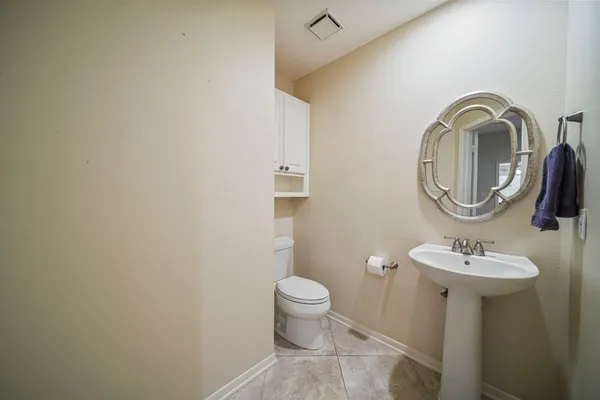 a spacious bedroom with a bed a window and ceiling fan