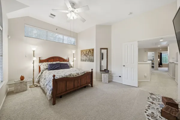 a kitchen with stainless steel appliances granite countertop a stove top oven a sink dishwasher a refrigerator and white cabinets with wooden floor