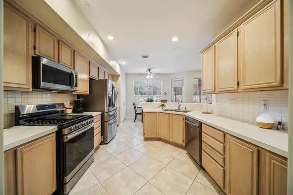 a bedroom with a bed and a flat tv screen next to a window