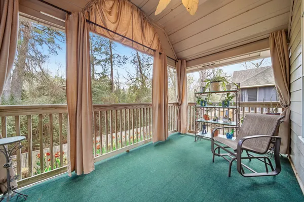 a living room with furniture a rug and a window