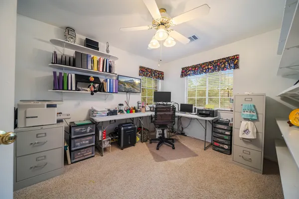 a room with gym equipment and wooden floor