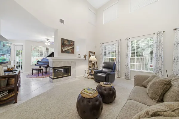 a living room with furniture and a floor to ceiling window