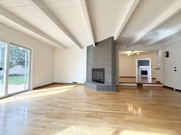 a view of empty room with a fireplace