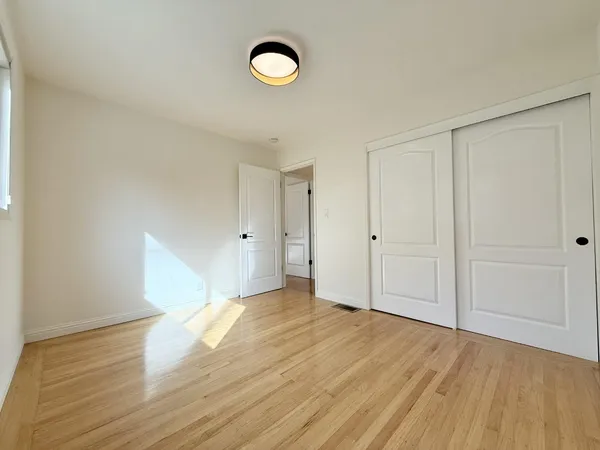 a bedroom with bed and a potted plant
