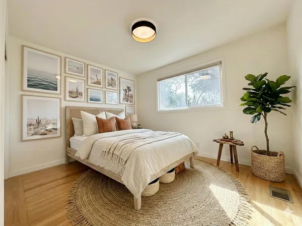 a bedroom with a bed and a potted plant