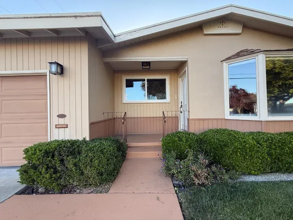 a view of empty room with wooden floor and fireplace