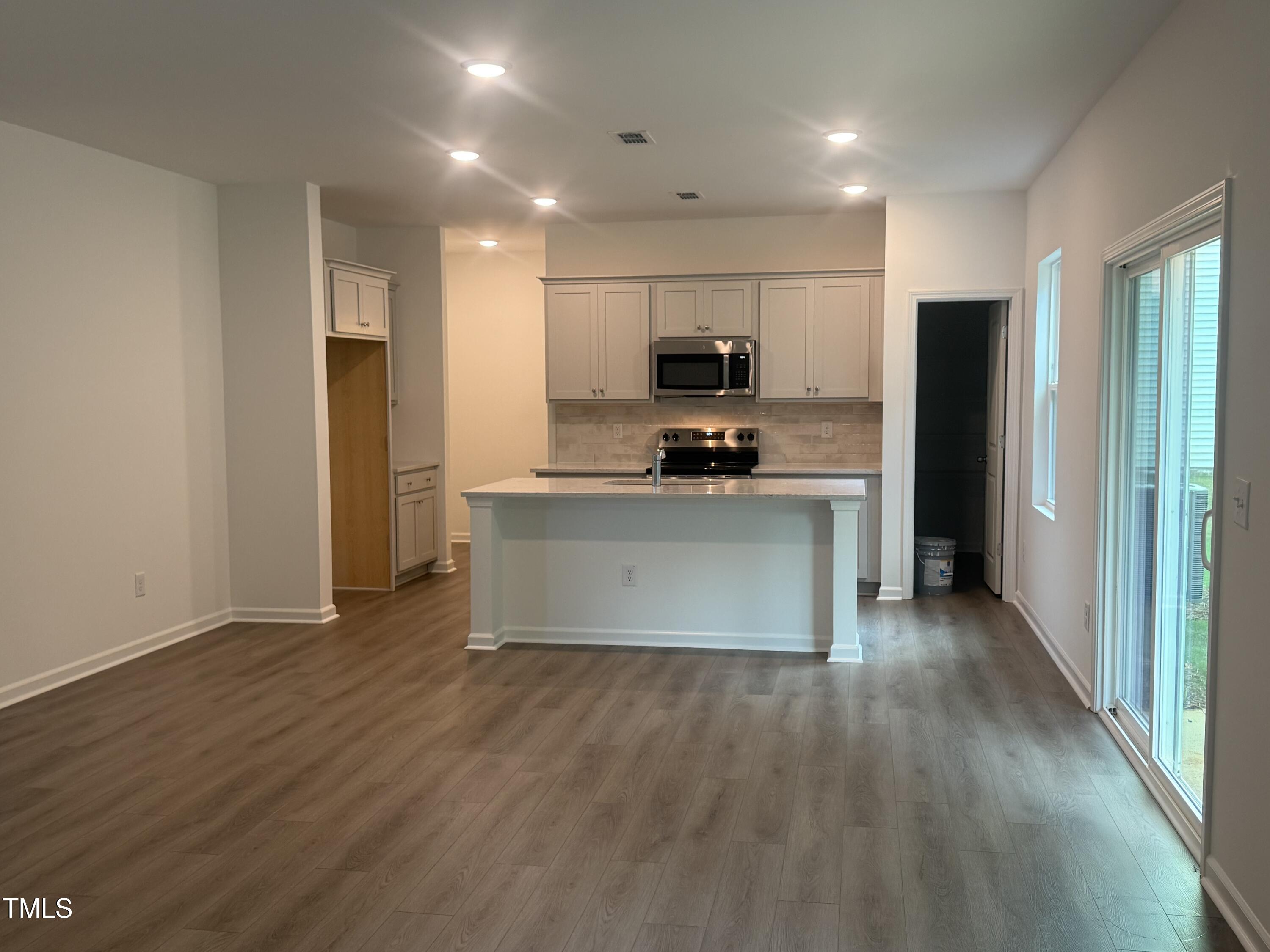6828 Galloway Drive Middlesex, NC 27557 - Photo 4 of 32 a kitchen with stainless steel appliances a sink a stove a refrigerator and a microwave