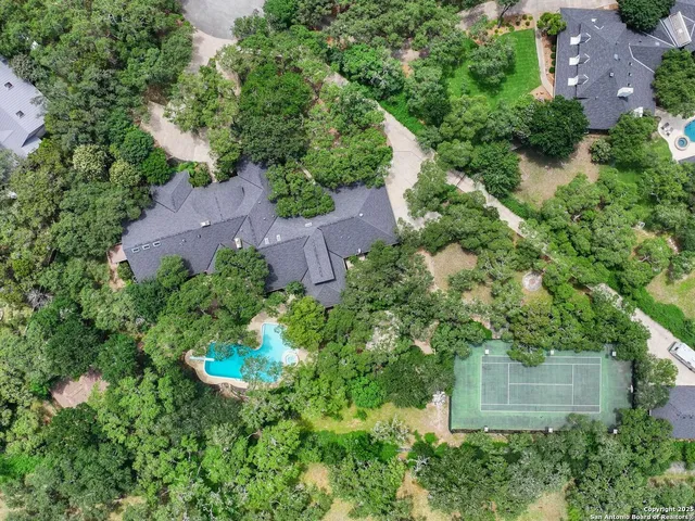 an aerial view of a house with a yard