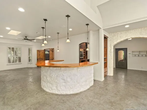 a living room with dining table and a flat screen tv