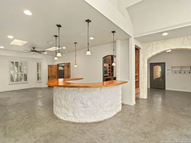 a living room with dining table and a flat screen tv