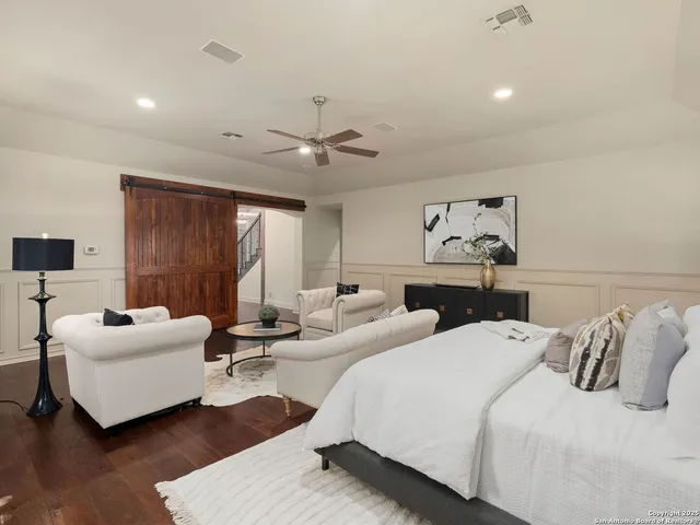 a living room with furniture and a dining table