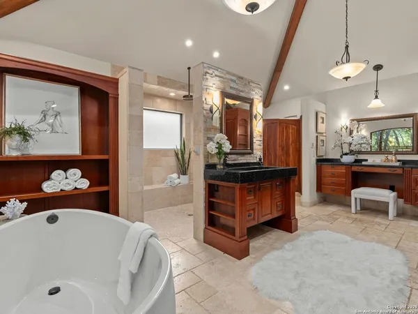 a bathroom with a bathtub and a painting on the wall
