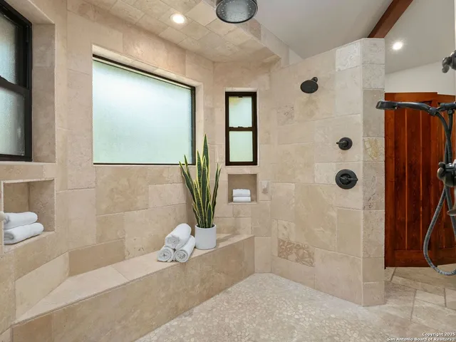 a dining room with wooden floor a chandelier a wooden table and chairs