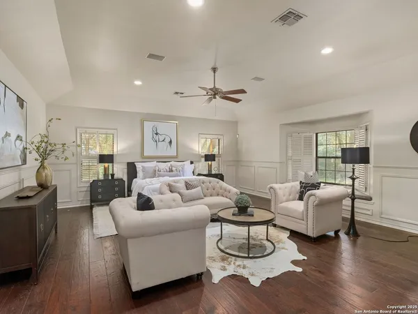 a living room with furniture or wooden floor and a chandelier