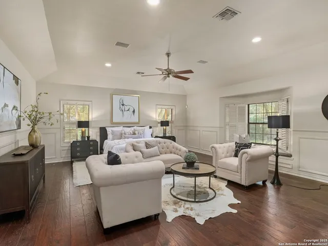 a living room with furniture or wooden floor and a chandelier