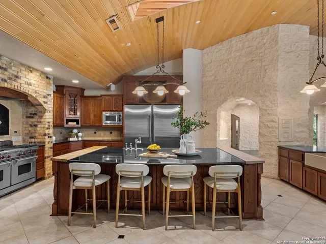 a kitchen with stainless steel appliances granite countertop a stove and a sink