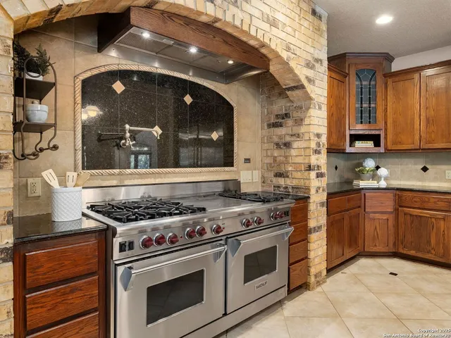 a dining room with wooden floor and large windows