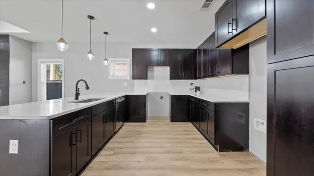 a large kitchen with stainless steel appliances kitchen island a sink counter space and cabinets
