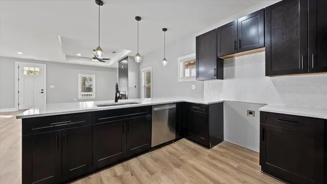 a kitchen with stainless steel appliances granite countertop a sink a stove and refrigerator
