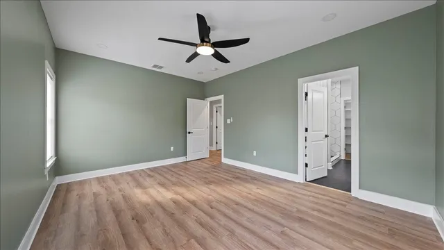 a view of empty room with wooden floor