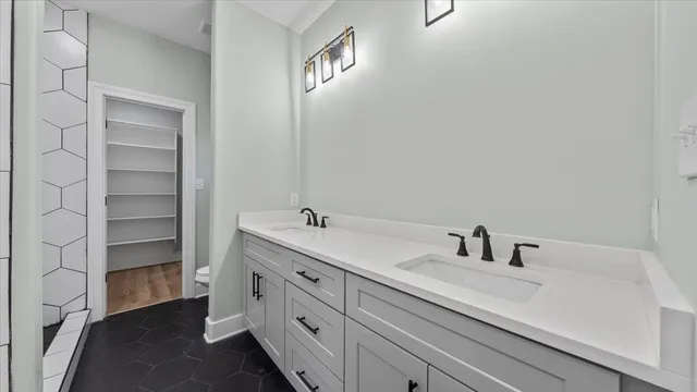 a bathroom with a sink double vanity and a mirror
