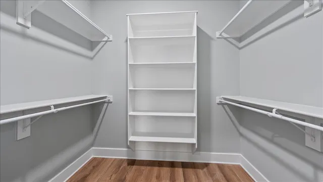 a view of walk in closet with empty racks
