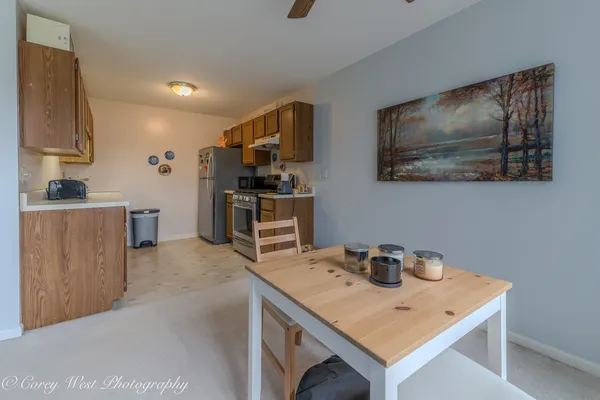 a view of kitchen island sink refrigerator and microwave