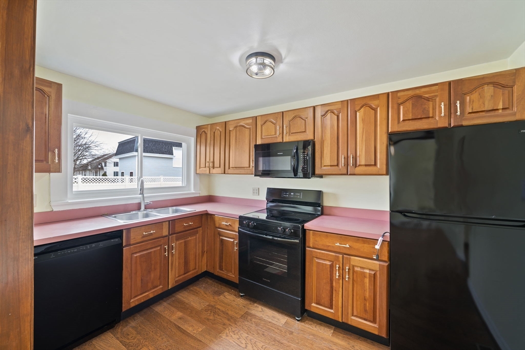 14 Crescent Road Weymouth, MA 02191 - Photo 3 of 19 a kitchen with stainless steel appliances granite countertop a refrigerator a sink dishwasher a stove top oven a refrigerator with island and chairs