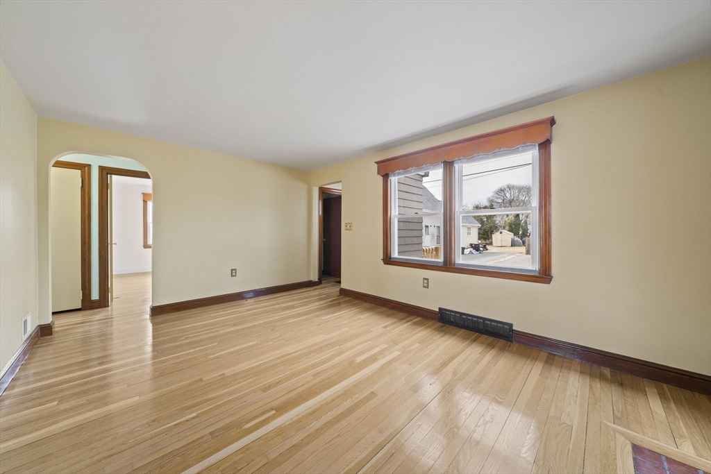 14 Crescent Road Weymouth, MA 02191 - Photo 5 of 19 a view of an empty room with wooden floor and a window