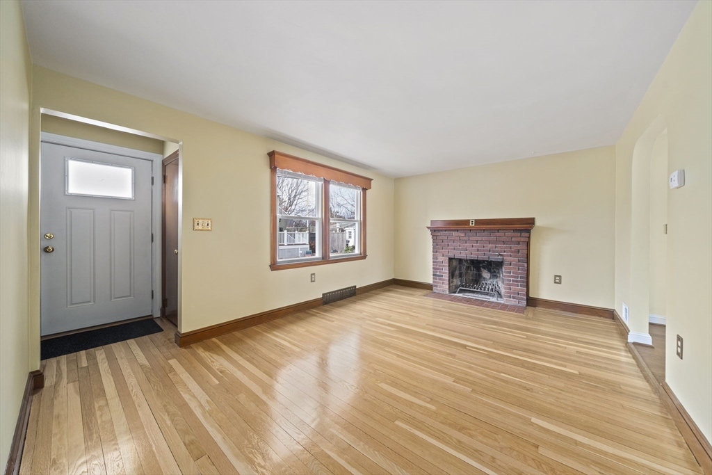 14 Crescent Road Weymouth, MA 02191 - Photo 6 of 19 a view of empty room with fireplace and wooden floor