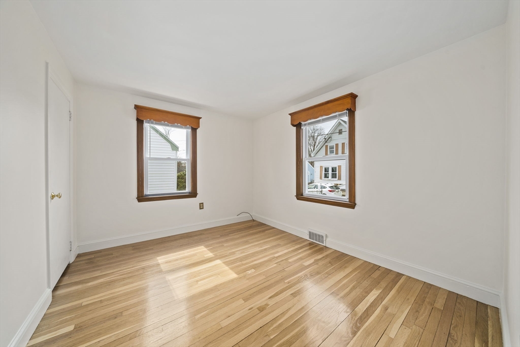 14 Crescent Road Weymouth, MA 02191 - Photo 7 of 19 a view of an empty room with window and wooden floor