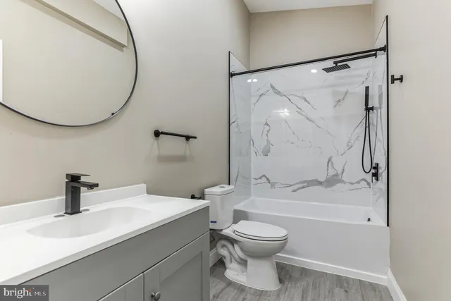 a bathroom with a sink a toilet and a mirror