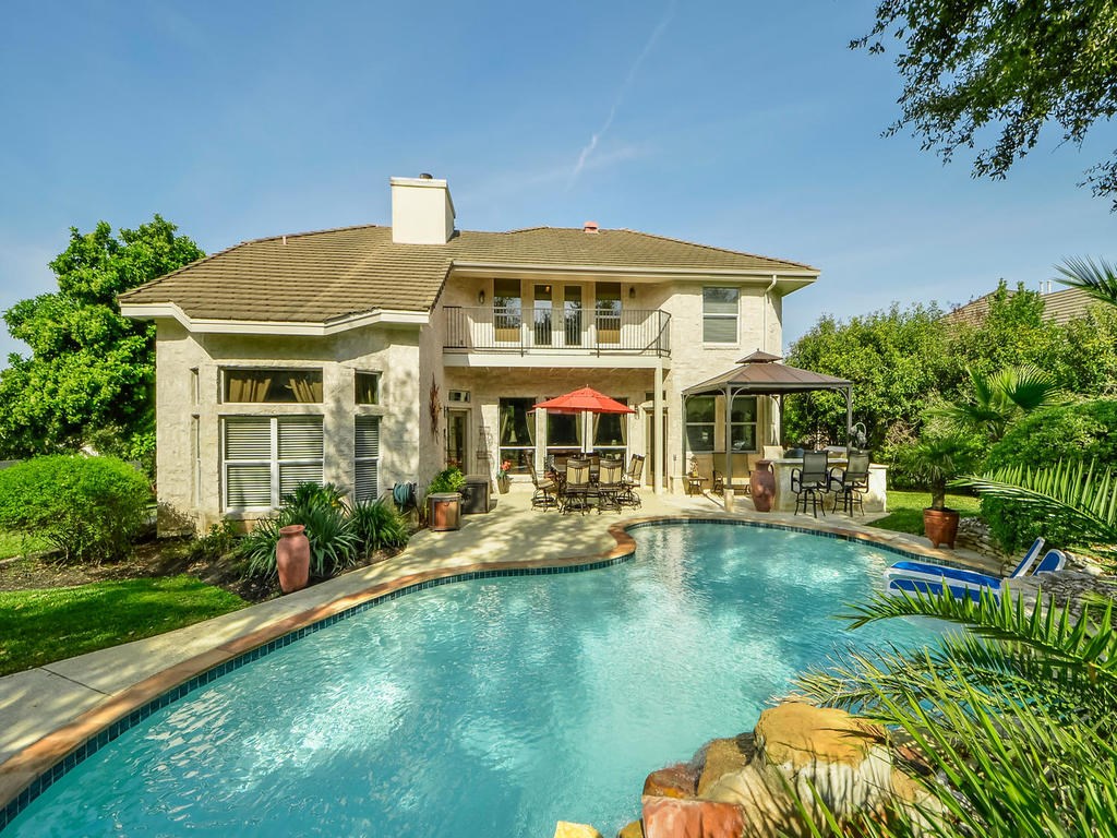 58 Cottondale Road The Hills, TX 78738 - Photo 1 of 1 a front view of a house with swimming pool having outdoor seating