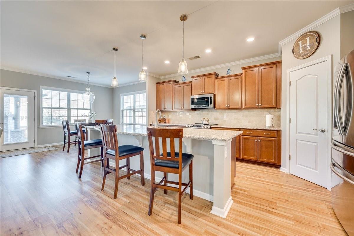2350 Talon Point Circle Fort Mill, SC 29715 - Photo 14 of 45 a kitchen with stainless steel appliances granite countertop a refrigerator a stove top oven a sink dishwasher and white cabinets with wooden floor