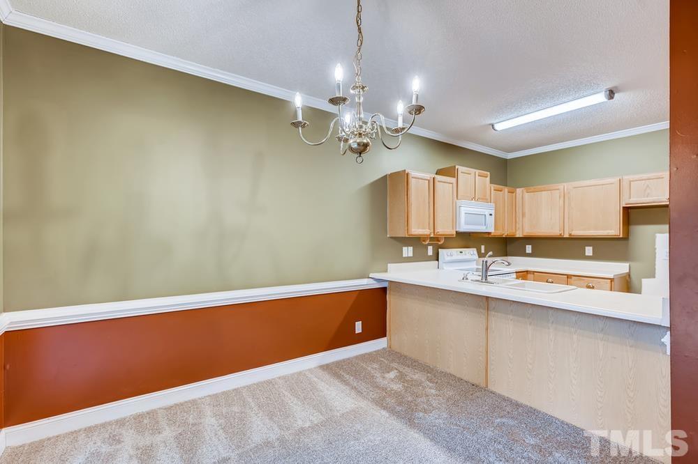 4008 Beaufain Street Raleigh, NC 27604 - Photo 11 of 30 a view of kitchen with granite countertop cabinets and chandelier