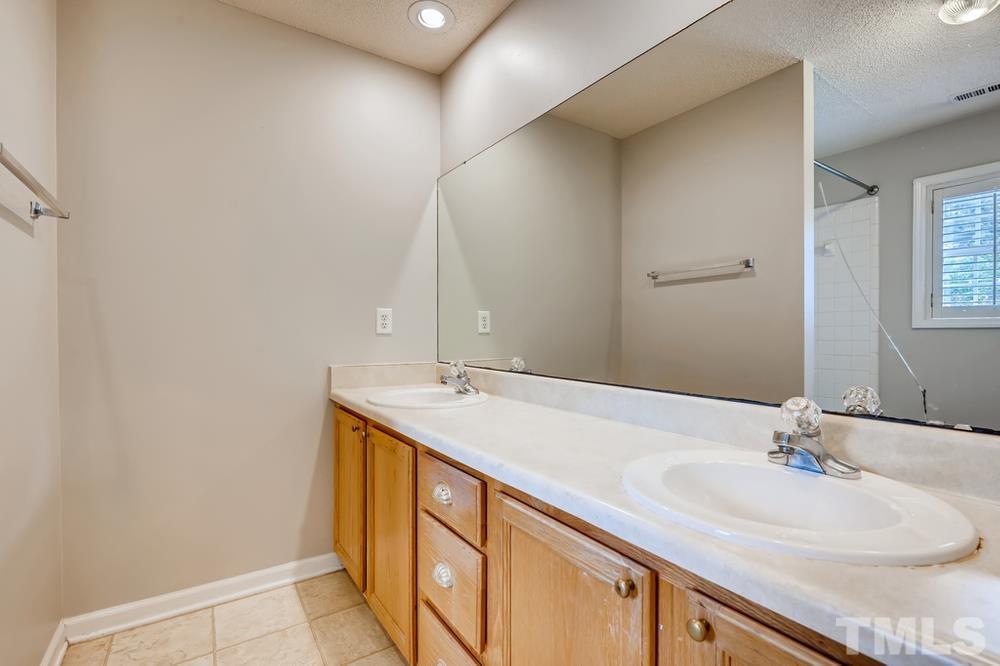 4008 Beaufain Street Raleigh, NC 27604 - Photo 20 of 30 a bathroom with a sink and a mirror