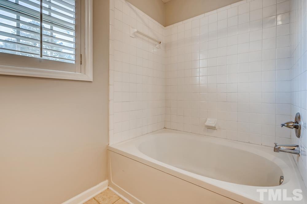 4008 Beaufain Street Raleigh, NC 27604 - Photo 21 of 30 a white bath tub sitting next to a window