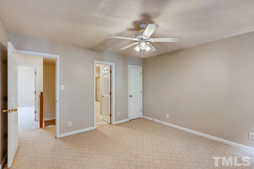 4008 Beaufain Street Raleigh, NC 27604 - Photo 27 of 30 an empty room with a ceiling fan and a window