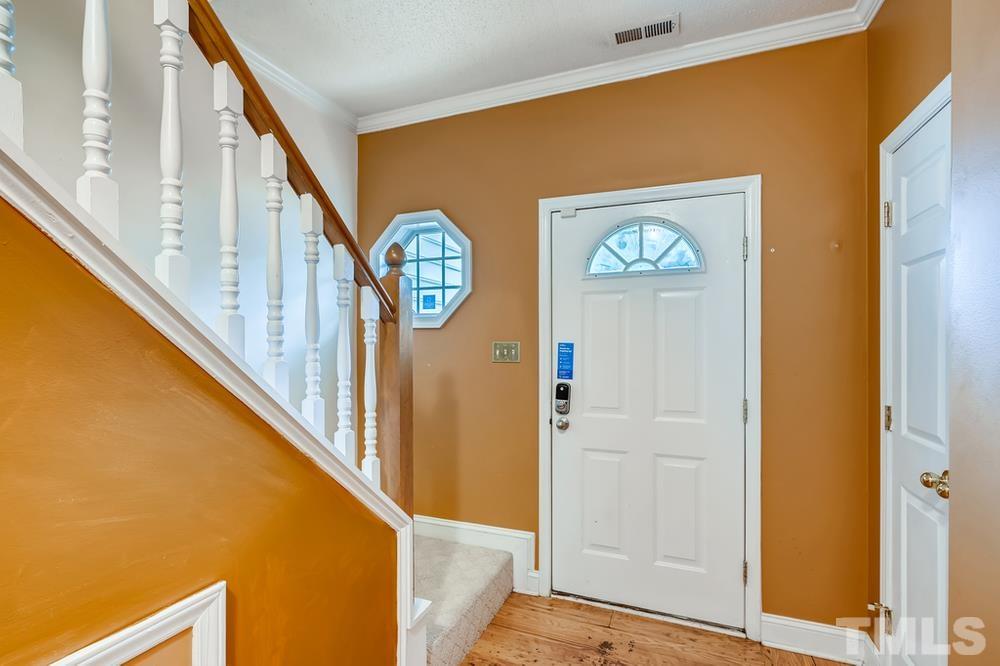 4008 Beaufain Street Raleigh, NC 27604 - Photo 5 of 30 a view of a hallway with wooden floor and door