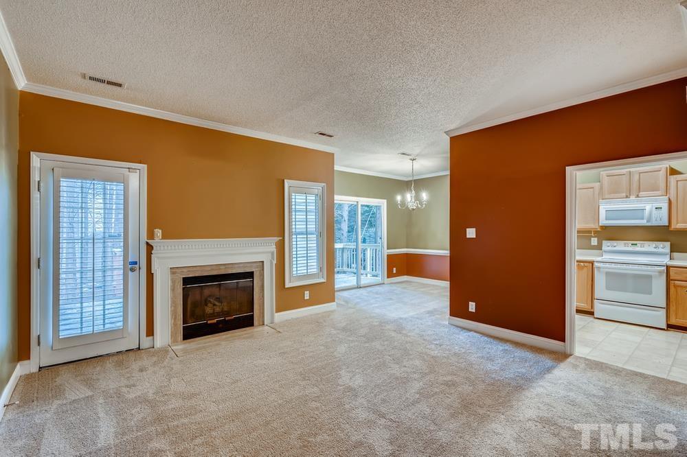 4008 Beaufain Street Raleigh, NC 27604 - Photo 6 of 30 an empty room with furniture and a fireplace