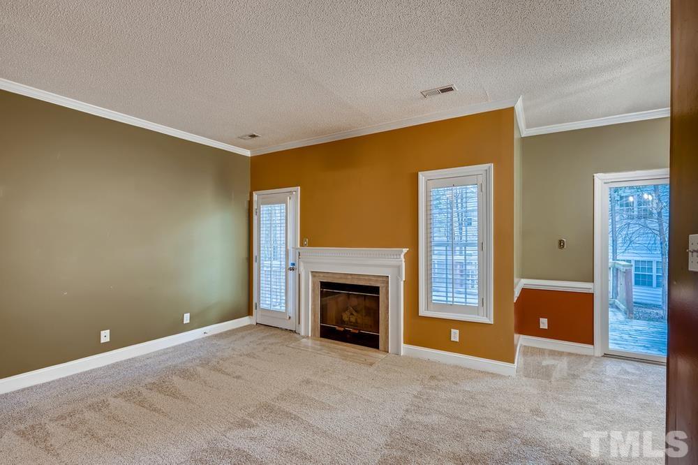 4008 Beaufain Street Raleigh, NC 27604 - Photo 7 of 30 a view of an empty room with a fireplace