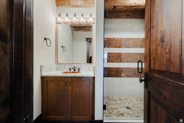 1667 West Tollgate Cyn Road Coalville, UT 84017 - Photo 39 of 61 Bathroom vanity with a wood-finish cabinet, stone countertop, and vessel sink