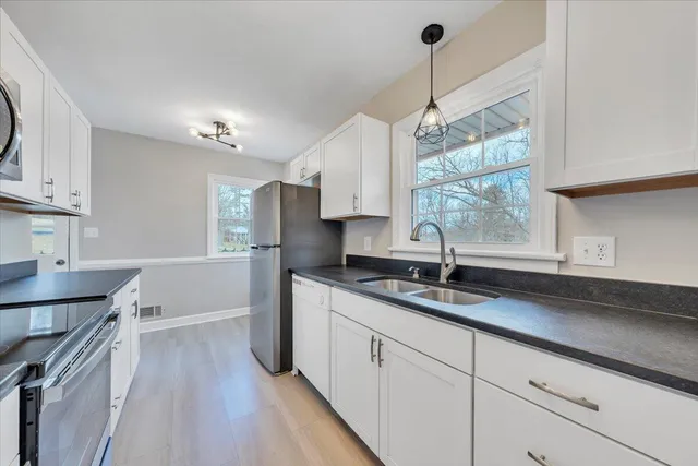 a kitchen with a sink stove and cabinets