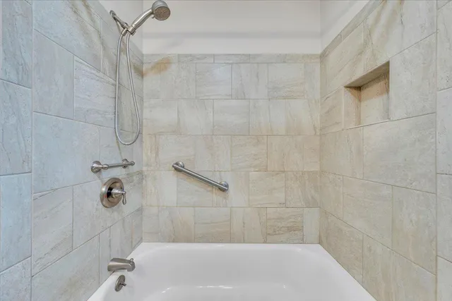 a bath tub sitting next to a shower