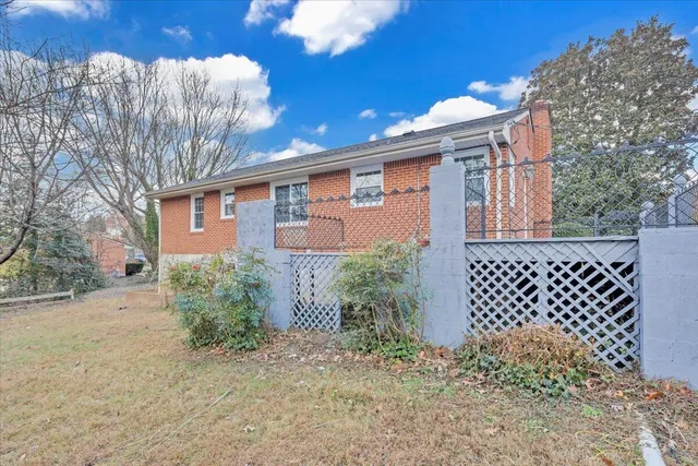 a view of a yard in front of a house with large tree